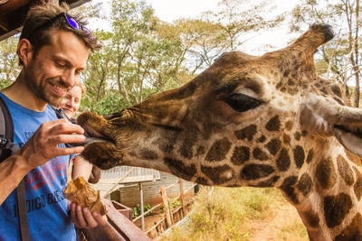 Vet Iain Hunt in Kenya feeding a giraffe